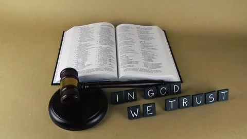 In God We Trust motto with Holy Bible and justice gavel Stock Footage 343370474
