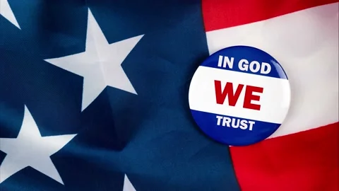 In god we trust text quote on election button laying on the star spangled ban Video stock 170629613