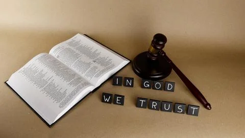 In God We Trust words, open Bible, and justice gavel Stock Photos