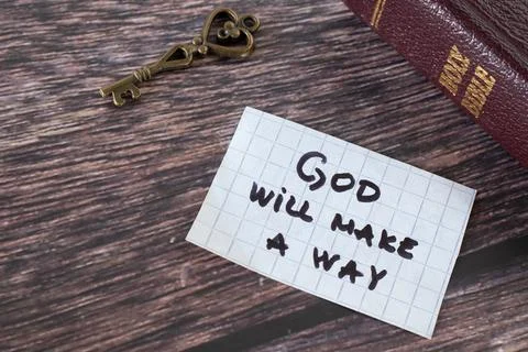 God will make a way, handwritten quote with ancient key and holy bible Stock Photos