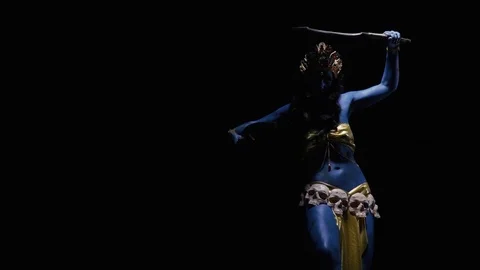 Goddess Kali in dramatic lighting is dancing with two blades Stock Footage 115763577