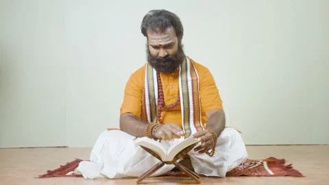 Godman is reading veda while sitting on mat Vídeo Stock 167079825