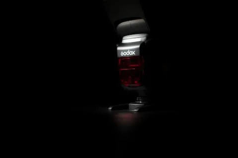 Godox flashlight on black, selective focus, low key photo Stock Photos