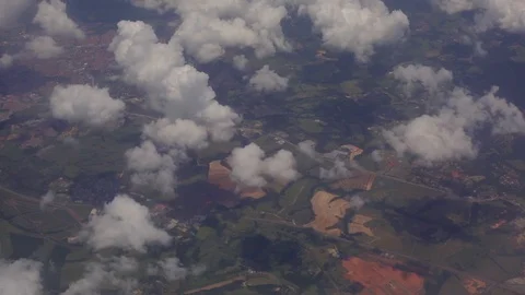 God's eye aerial looking down at human towns on the earth through small clouds Stock Footage 101302432
