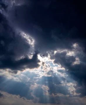 Gods light. Rays of light through dark clouds. sun shines from cloud Stock Photos