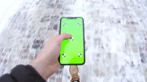 Goes touching the greem screen phone with one hand, then turns horizontally Stock Footage 148942212