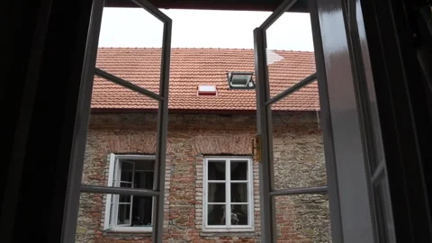 Goes to the window in the old villa Stock Footage 278406569