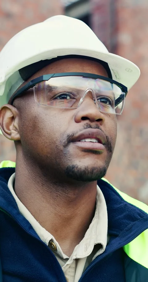 Goggles, hard hat and thinking with black man on construction site for Stock Footage 336797226