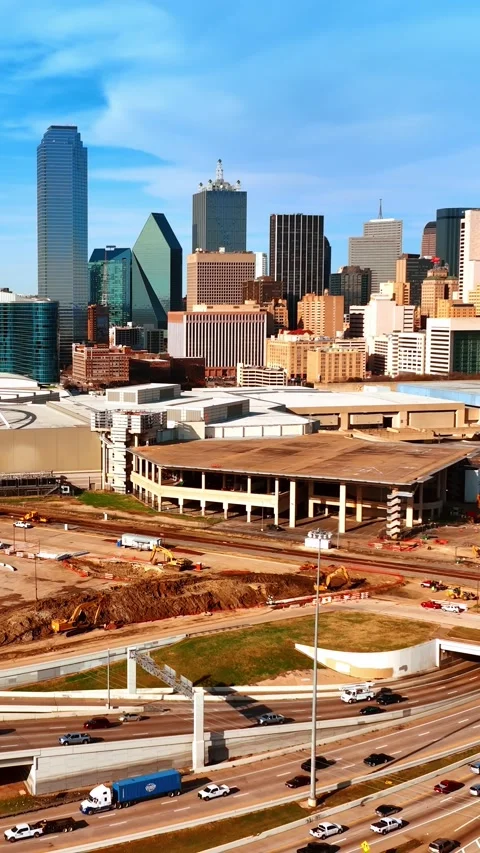 Going up above the busy roads in modern city. Drone flying over the construction Stock Footage 332345857