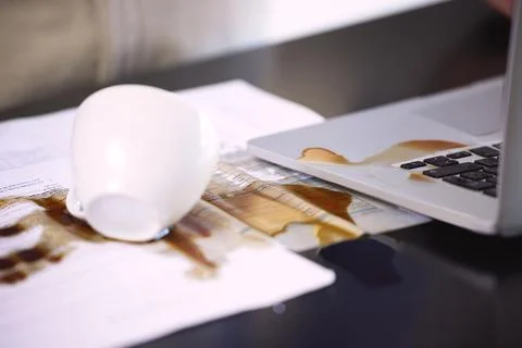 This is going to be quite the mess to fix. Closeup shot of coffee spilt over  库存照片