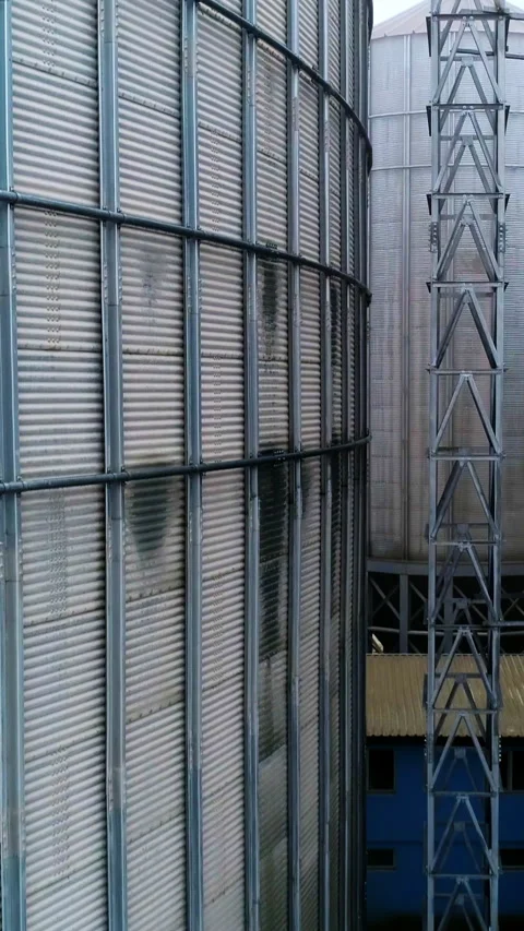 Going up between two metal elevator tanks to the tops.  Stock Footage 273768316