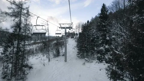 Going up on the cableway in the snowy mountains Stock Footage 132243665