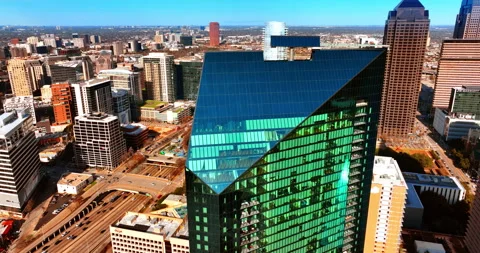 Going down along the façade of a modern high-rise building reflecting sunlight. Stock Footage 264365327