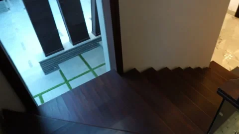 Going Down Dark Brown Wooden Staircase With Glass Railing. Follow Shot Stock Footage 153668902