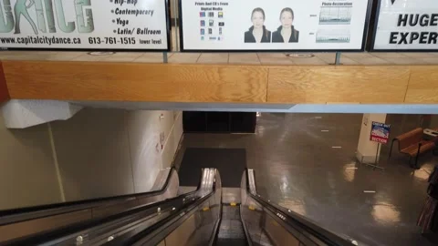 Going down an escalator in a mall Stock Footage 143986080