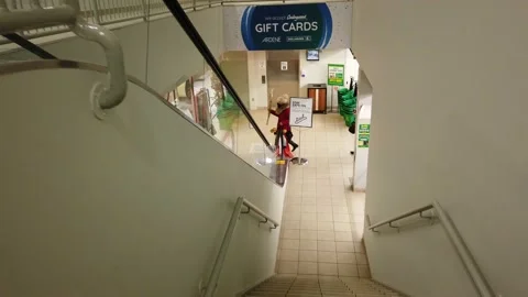 Going down an escalator in a shopping mall Stock Footage 143985914