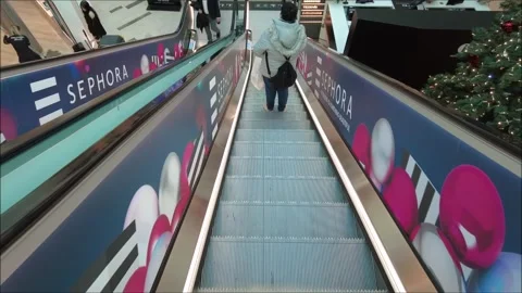 Going down an escalator in a shopping mall before Christmas Stock Footage 295885474