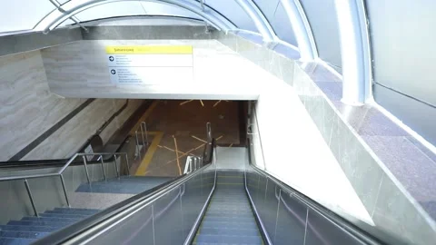 Going down modern escalator at metro station Stock Footage 233992352