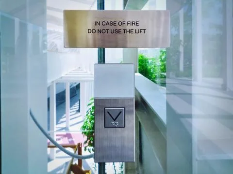 Going Down Push Button on Elevator with Braille Alphabet Stock Photos