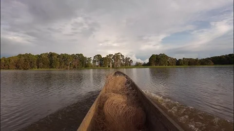 Going down the river in a wooden boat Stock Footage 325554816