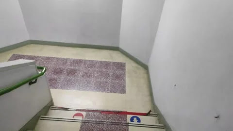 Going down a stair in concrete building Stock Footage 258946996