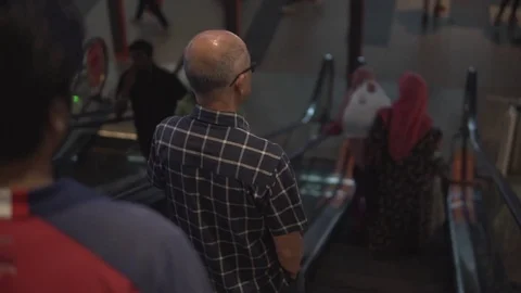 Going down a subway escalator behind the people who stay onto the platform 動画素材 81696031