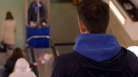 Going down a subway escalator with commuters who step onto the platform Stock Footage 82862148