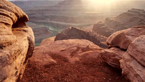 Going to edge of cliff to see view on red rocks and Colorado River during sunset Stock-Footage 132124927