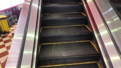 Going up an escalator inside a modern airport shopping mall, gateway klia2 Stock Footage 340939518