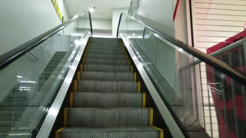 Going up an escalator in a shopping mall Stock Footage 143985930