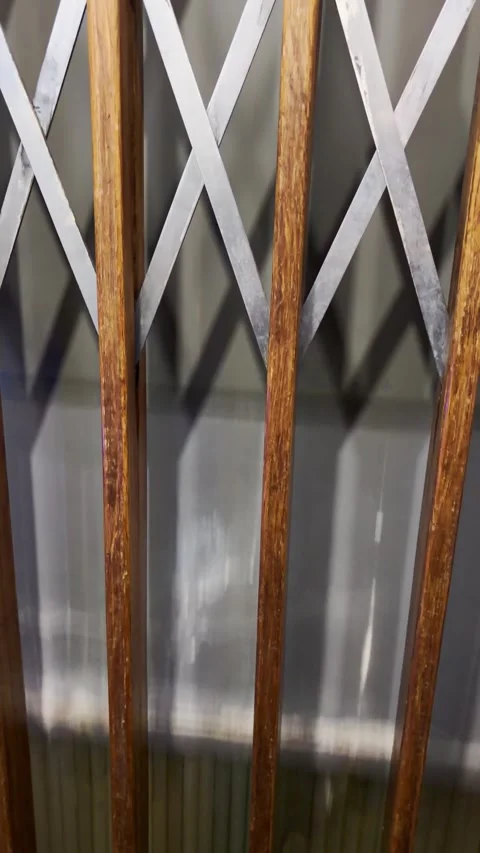 Going up inside old elevator lift in European building with wooden door and Stock Footage 341875873