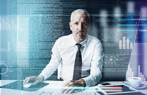 Going over the code. Cropped portrait of a mature businessman working on Stock Photos