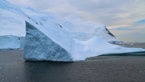 Going past an iceberg mountain and glacier in Antarctica 1 Stock Footage 87340425