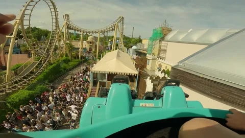 Going up with a roller coaster with a beautiful view over the park. Stock Footage 247133898