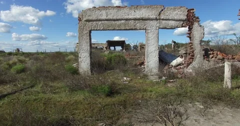 Going through the frame of a destroyed doors house. Sad urban landscape. Video stock 56042041