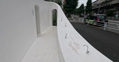 Going through an unusual white public toilet in Tokyo, Japan, opening water tap Stock Footage 255993312