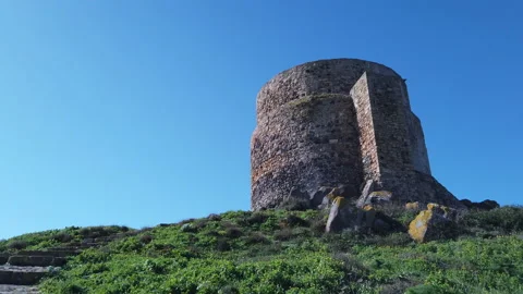 Going up to the top of the hill with a coastal tower in a windy day Stock Footage 148541981