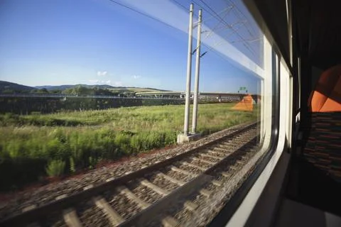 Going by train and watching landscape from the window. Travelling by public t Stock Photos