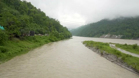 Going by train over the river in the rainy season Stock Footage 158148972