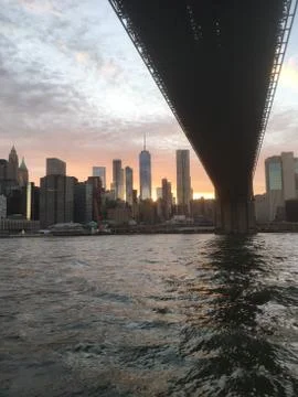 Going under the Brooklyn Bridge in a ferry on the East River, NYC. Stock Photos
