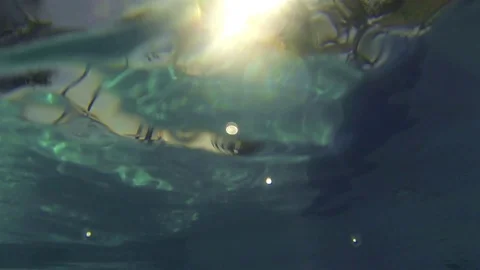 Going Underwater With Waterproof Camera In Swimming Pool Facing Sun - Slide - Stock Footage 92834375