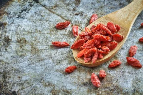 Goji berries on rustic background Stock Photos