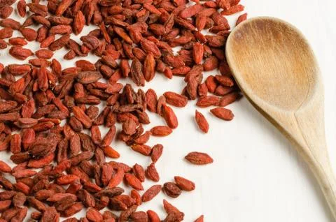 Goji berry dried, with spoon, closeup background.. Stock Photos