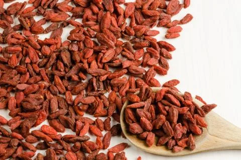 Goji berry dried, with spoon, closeup background.. Stock Photos