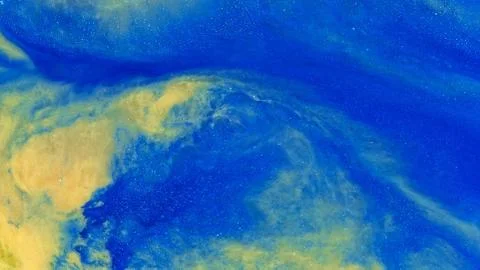 Gold and blue explode 2 vibrant bright paint and oil color swirls entropy Fotos de archivo