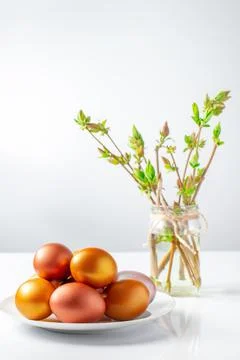 Gold and bronze Easter eggs on white background. Christian holiday symbol. Stock Photos