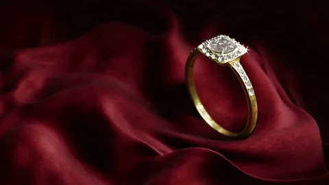 Gold and diamond ring on dark red velvet. Stock Footage 232003755