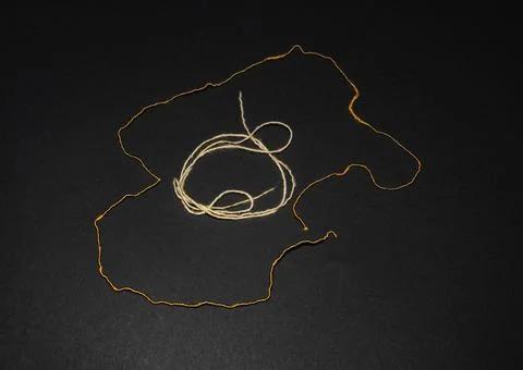 Gold and regular thread, two threads folded into an oval Stock Photos