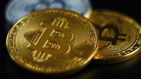 Gold and silver bitcoins lie on a black background. Stock Footage