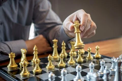 Gold and silver chess with player, Intelligent businessman playing chess game Stock Photos